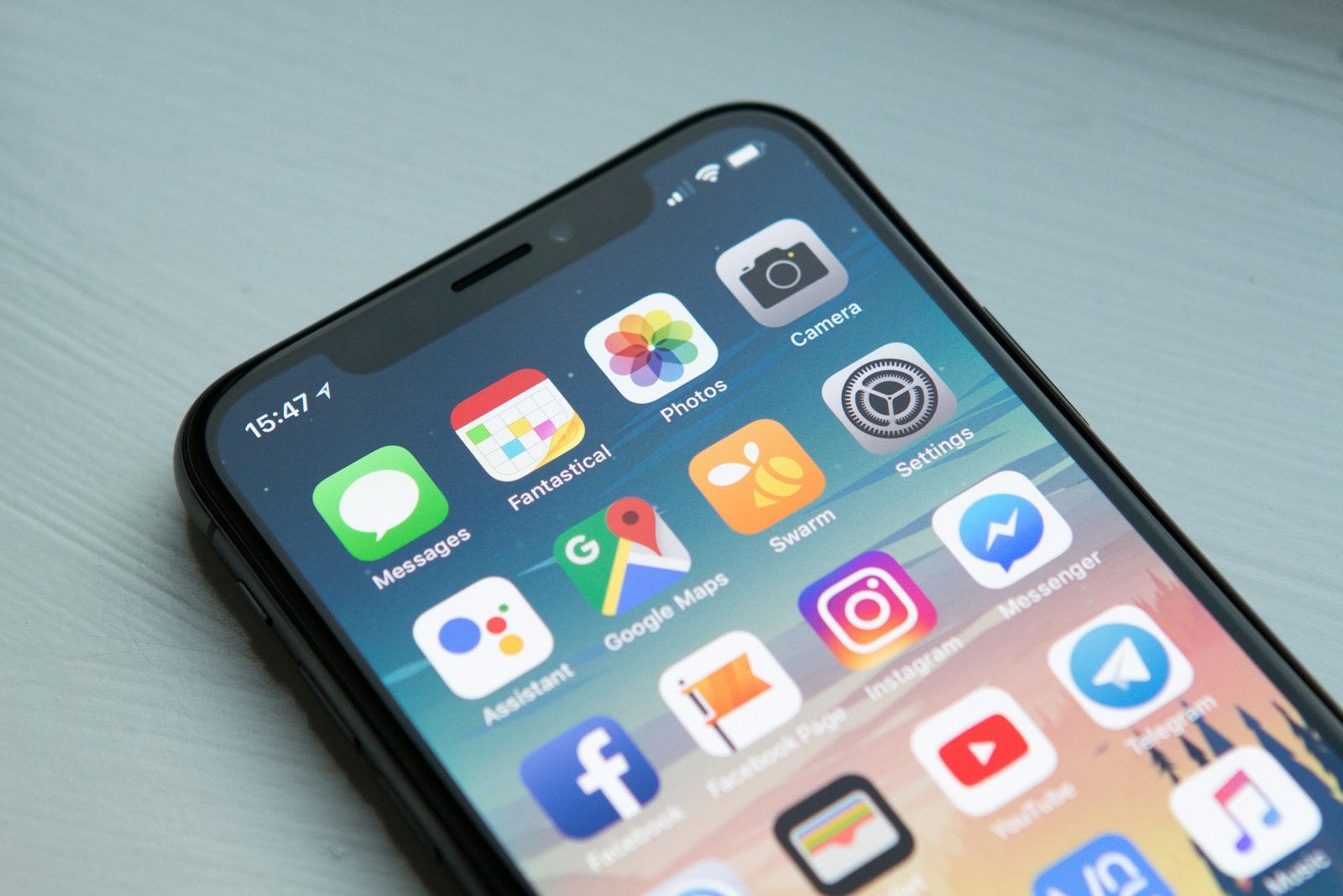 Smartphone with social media apps, Threads vs Bluesky vs X marketing comparison for small business 2026